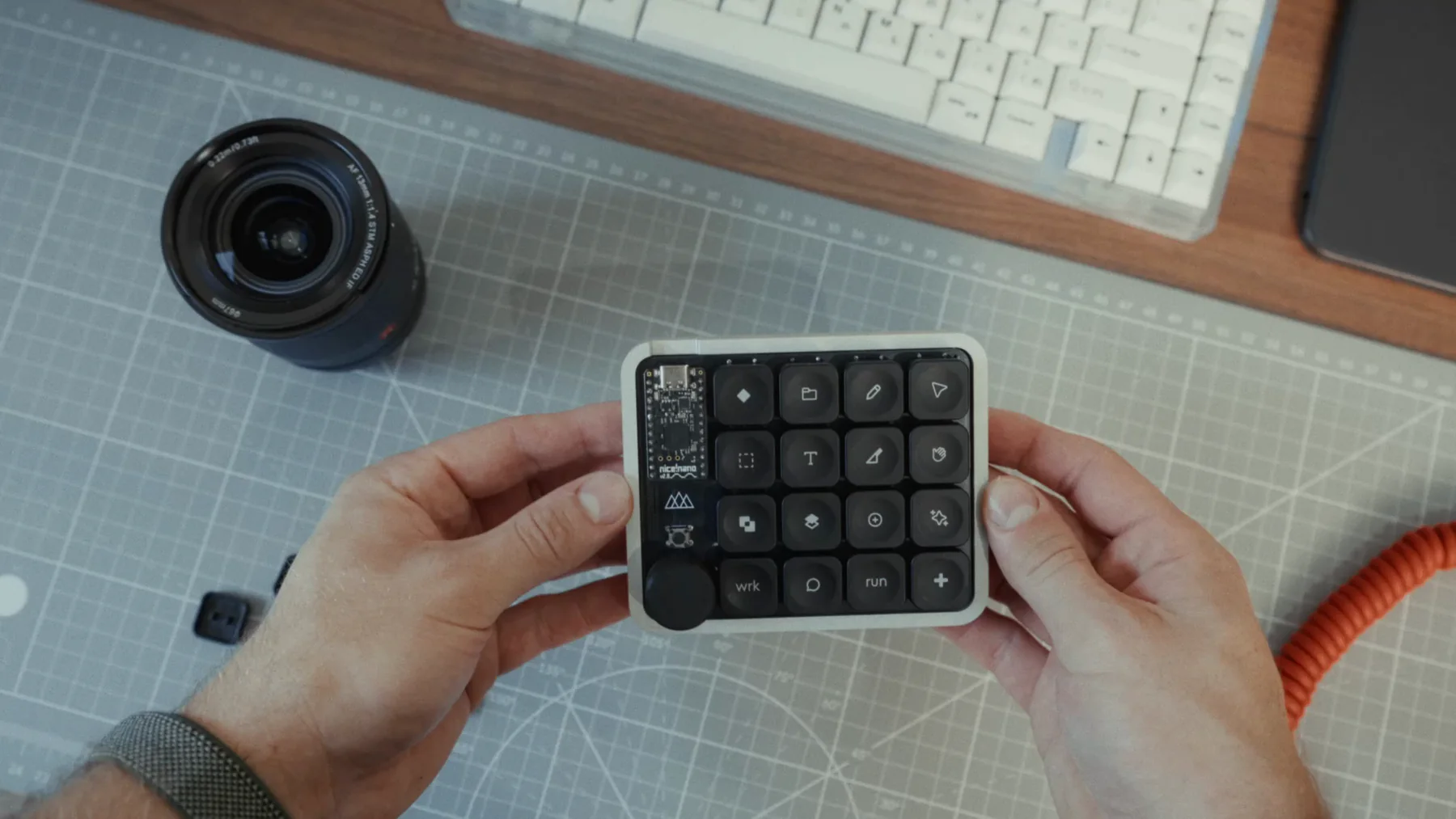 The MinimalPad held in two hands above a cutting mat
